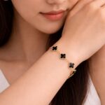 Anti-tarnish 18K gold plated midnight black clover motif bracelet for women featuring gold-rimmed flower charms on a link chain by YouGorgeous.