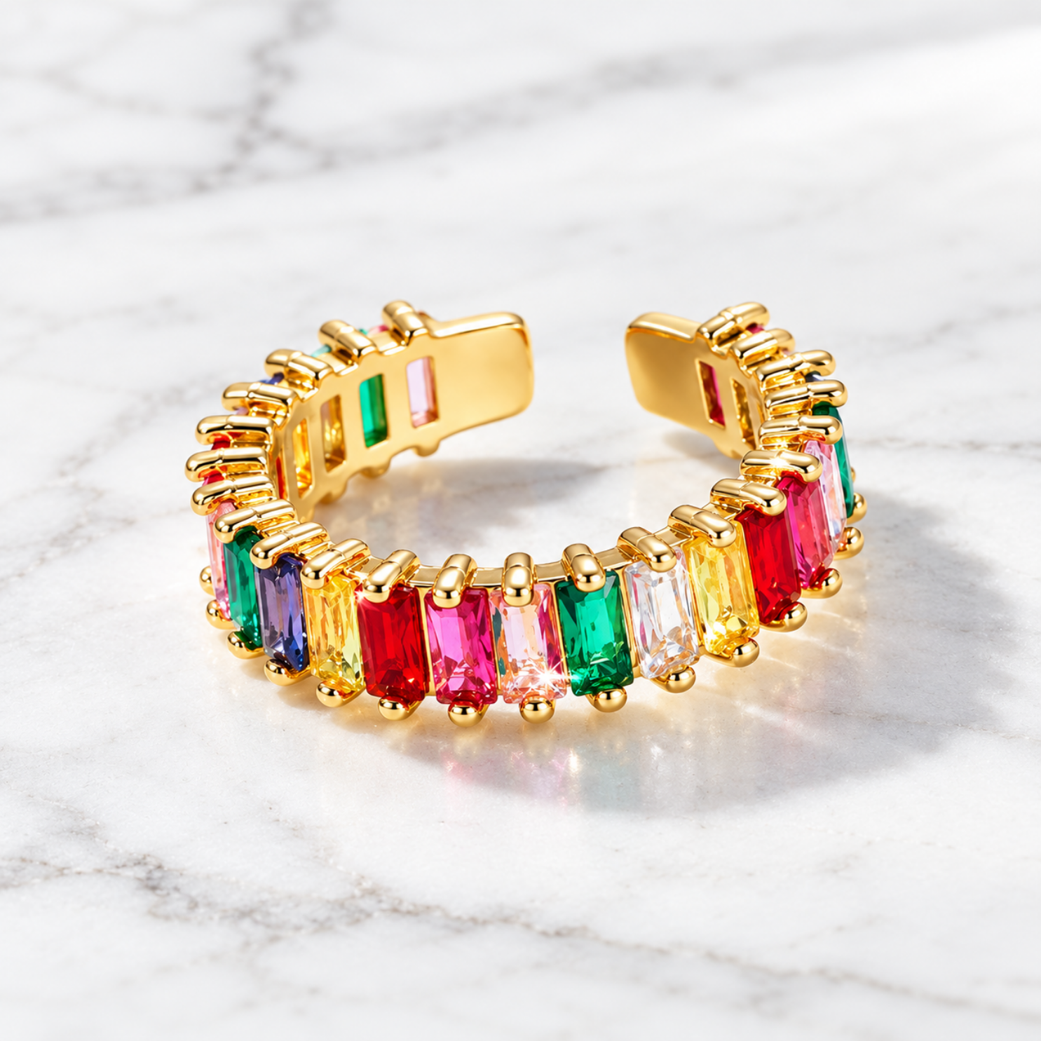 Macro detail of faceted rectangular rainbow baguette crystals in rounded golden prong settings Macro detail of faceted rectangular rainbow baguette crystals in rounded golden prong settings