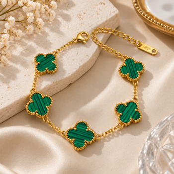 Model wearing Yougorgeous green clover station bracelet stacked alongside an 18K gold watch