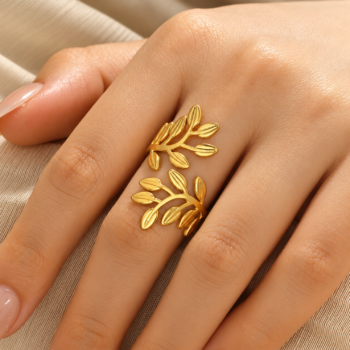 Macro detail of sculpted laurel branch leaves and embossed ridge accents on olive leaf adjustable ring