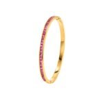 Yougorgeous 18K gold pink crystal tennis bangle with channel set stones on white background