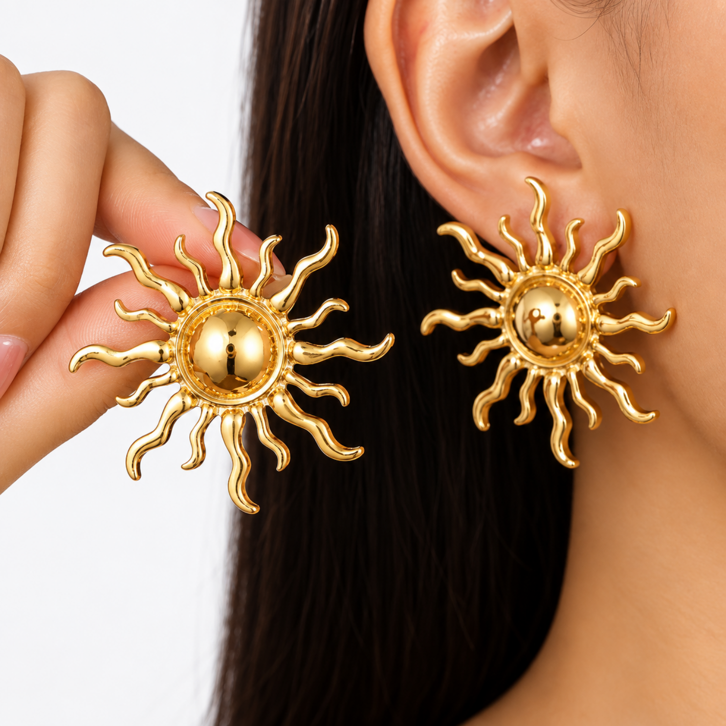 Model wearing Yougorgeous bold gold celestial sun statement studs on earlobe Model wearing Yougorgeous bold gold celestial sun statement studs on earlobe