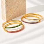 Yougorgeous 18K gold pink crystal tennis bangle with channel set stones on white background