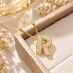 Yougorgeous 18K gold bubble letter R necklace with crystal pavé on white background