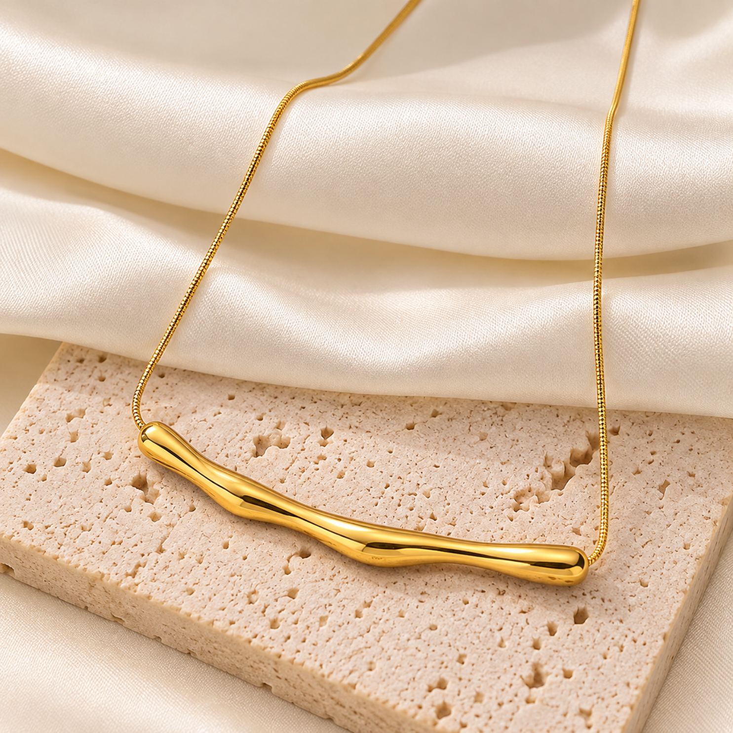 93 Close-up of curved molten tube pendant showing fluid liquid gold mirror finish